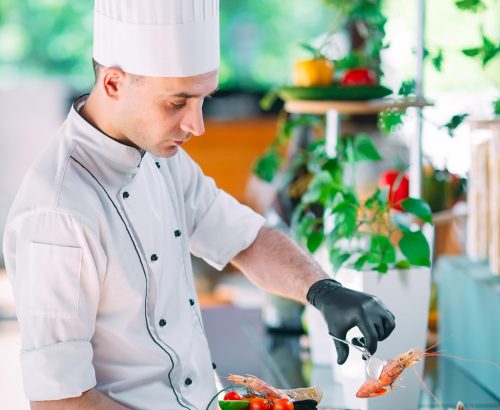 the-chef-puts-the-seafood-on-a-tray-in-the-restaurant